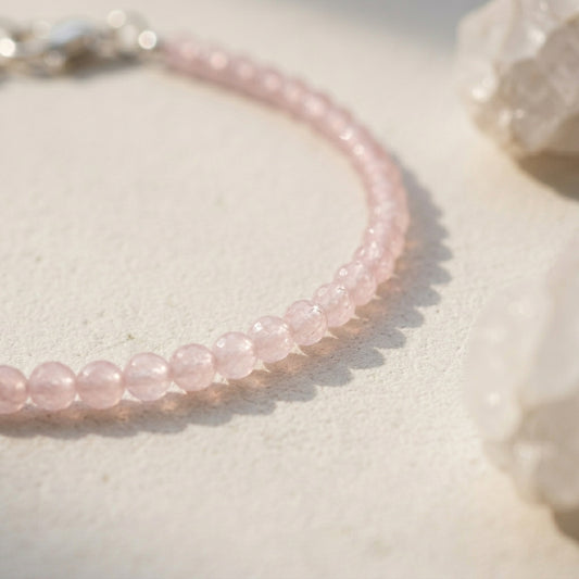 Pink beaded bracelet on a light background