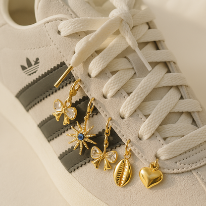 Gold earrings on a white sneaker with Adidas logo