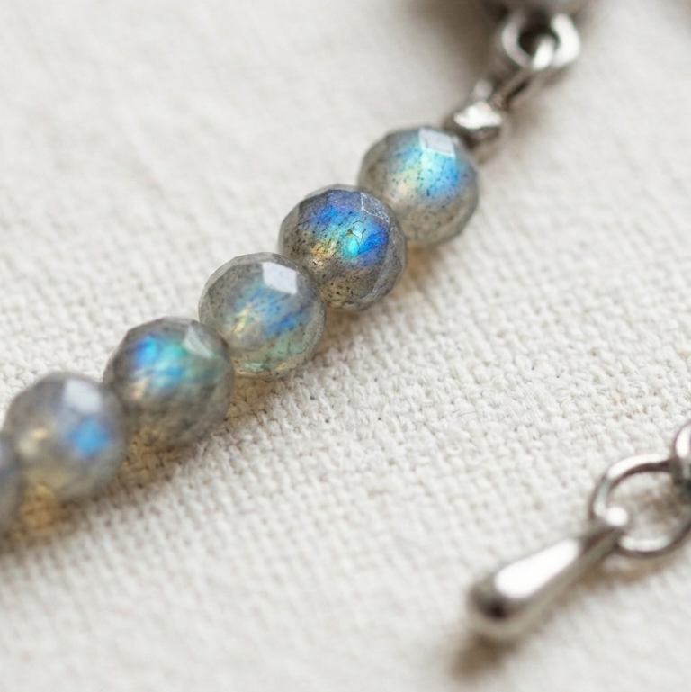 Bracelet with heart clasp and beaded chain on a light background