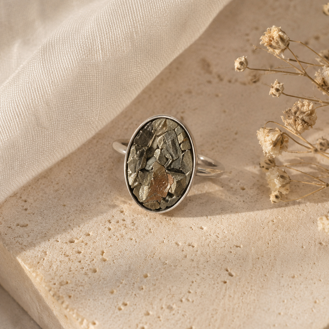 Silver ring with a natural stone on a beige fabric background