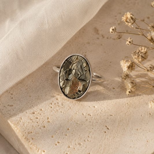 Silver ring with a natural stone on a beige fabric background